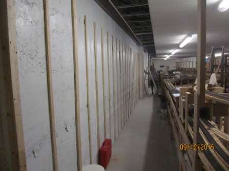 A very rough concrete outer wall strapped and awiting drywall installation.